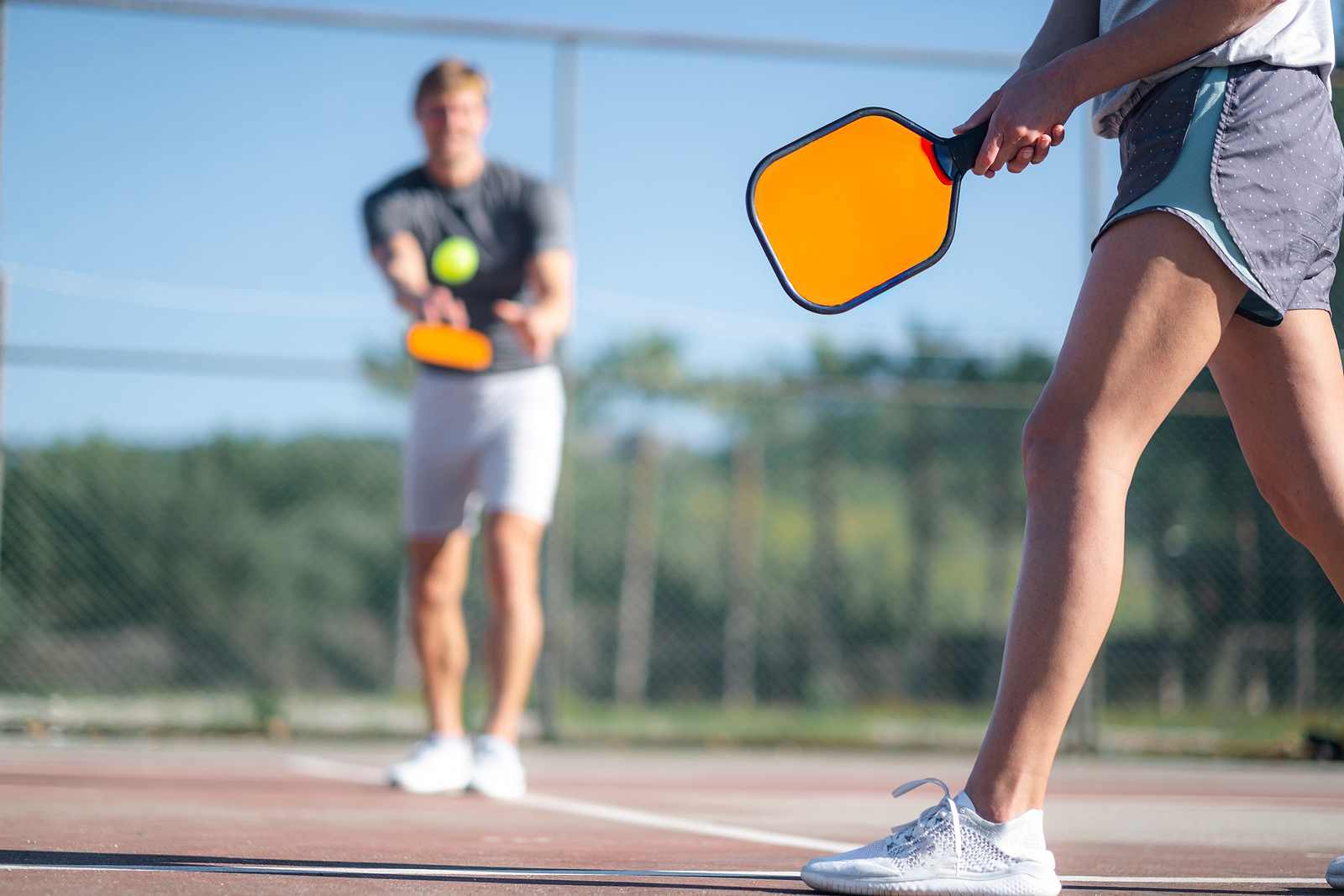 bigstock-Couple-Playing-Pickleball-Game-470232579